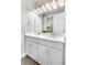 Bright bathroom with dual sinks, modern vanity, and well-lit mirror reflecting a luxurious shower at 9340 Mount Jackson St, Littleton, CO 80125