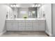 Elegant bathroom with double sinks, modern cabinets, and a large mirror for a spacious feel at 9340 Mount Jackson St, Littleton, CO 80125