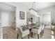 Dining room with hardwood floors, modern chandelier, and easy access to the kitchen and outdoor patio at 9340 Mount Jackson St, Littleton, CO 80125