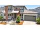 Charming two-story home with modern gray and brick exterior, complemented by a lush, landscaped front yard at 9340 Mount Jackson St, Littleton, CO 80125