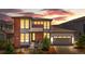 Beautiful two-story home with a brick and gray exterior and a manicured front yard at sunset at 9340 Mount Jackson St, Littleton, CO 80125