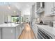 Contemporary kitchen with white cabinetry, stainless steel appliances, and hardwood floors at 9340 Mount Jackson St, Littleton, CO 80125