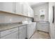 Functional laundry room with granite countertops, ample cabinet storage, and modern appliances at 9340 Mount Jackson St, Littleton, CO 80125