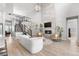 Spacious living area with a fireplace and staircase, complemented by hardwood floors and natural light at 9340 Mount Jackson St, Littleton, CO 80125