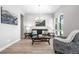 Bright living room featuring modern decor and wood floors, bathed in sunlight from the large window at 9340 Mount Jackson St, Littleton, CO 80125