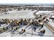 Aerial view of a neighborhood showcasing houses, roads, and snowy landscape at 7260 Fallon Cir, Castle Rock, CO 80104