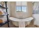 Elegant bathroom with a freestanding soaking tub and window at 7260 Fallon Cir, Castle Rock, CO 80104