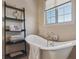 Bathroom with a freestanding soaking tub and window at 7260 Fallon Cir, Castle Rock, CO 80104