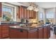 Open kitchen with island, stainless appliances, and lots of cabinets at 7260 Fallon Cir, Castle Rock, CO 80104