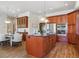 Kitchen with island, stainless steel appliances, and wood cabinets at 7260 Fallon Cir, Castle Rock, CO 80104