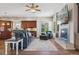 Open living room with fireplace, comfy seating, and kitchen views at 7260 Fallon Cir, Castle Rock, CO 80104