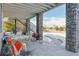 Covered patio with stone columns and snowy view at 7260 Fallon Cir, Castle Rock, CO 80104