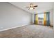 Spacious bedroom with plush carpeting, a ceiling fan, and a large window with coverings at 795 S Alton Way # 5D, Denver, CO 80247