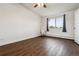 Bright bedroom featuring hardwood floors, a ceiling fan, and a large window with coverings at 795 S Alton Way # 5D, Denver, CO 80247