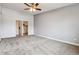 Spacious bedroom features neutral carpet, ceiling fan, and closet access at 795 S Alton Way # 5D, Denver, CO 80247