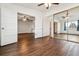 A bright bedroom boasts hardwood floors, mirrored closet, and ceiling fan at 795 S Alton Way # 5D, Denver, CO 80247