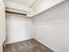 The walk-in closet has carpeted floors, white walls, shelves, and a hanging rack at 795 S Alton Way # 5D, Denver, CO 80247