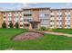 Apartment building exterior with manicured lawn and landscaping at 795 S Alton Way # 5D, Denver, CO 80247