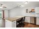 Open kitchen with granite countertops, stainless steel appliances, and barstool seating at 795 S Alton Way # 5D, Denver, CO 80247