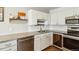 Updated kitchen with granite counters, stainless steel appliances, and sleek white cabinetry at 795 S Alton Way # 5D, Denver, CO 80247