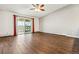 A living room features wood flooring, balcony doors, and a ceiling fan at 795 S Alton Way # 5D, Denver, CO 80247