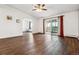 A living room features wood floors, a ceiling fan, balcony access, and office access at 795 S Alton Way # 5D, Denver, CO 80247