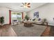 A bright living room with a balcony, wooden table, and light gray carpet at 795 S Alton Way # 5D, Denver, CO 80247