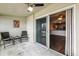 Enclosed patio with outdoor furniture, ceiling fan, and a sliding glass door leading to the interior living space at 795 S Alton Way # 5D, Denver, CO 80247
