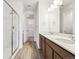 Double vanity bathroom with a large mirror and a walk-in shower at 6575 N Nepal St, Aurora, CO 80019