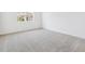 Simple carpeted bedroom with large window and neutral walls at 6575 N Nepal St, Aurora, CO 80019