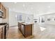 Modern kitchen with island, stainless steel appliances, and wood cabinets at 6575 N Nepal St, Aurora, CO 80019