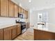 Modern kitchen with wood cabinets, stainless steel appliances, and quartz countertops at 6575 N Nepal St, Aurora, CO 80019
