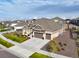 Aerial view of a single-Gathering home showcasing its well-manicured yard, three-car garage and neighborhood at 8890 S Quatar Ct, Aurora, CO 80016