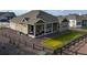Spacious backyard, featuring gravel, a patch of grass, and covered patio at 8890 S Quatar Ct, Aurora, CO 80016