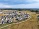 Expansive aerial view of a suburban neighborhood with walking paths and mountain views in the distance at 8890 S Quatar Ct, Aurora, CO 80016
