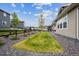 Landscaped backyard featuring gravel, a patch of grass, and a view of the neighboring homes and fence at 8890 S Quatar Ct, Aurora, CO 80016