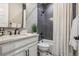 A charming bathroom with dark grey tiled shower and bright white floor at 8890 S Quatar Ct, Aurora, CO 80016