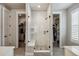 This is a bathroom with a shower and dual walk in closets at 8890 S Quatar Ct, Aurora, CO 80016