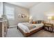 Bedroom showcases a cozy bed, minimalist decor, and natural light at 8890 S Quatar Ct, Aurora, CO 80016