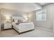 Cozy bedroom featuring a white bed frame, plush bedding, neutral walls, and a bright window at 8890 S Quatar Ct, Aurora, CO 80016
