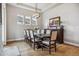 Bright dining room features a large table with seating for eight and classic decor at 8890 S Quatar Ct, Aurora, CO 80016