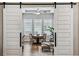 Dining room boasts a tray ceiling, large windows with shutters and is open to the kitchen and living room at 8890 S Quatar Ct, Aurora, CO 80016