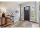 Bright foyer featuring wood floors, stylish console table and neutral decor, perfect for a warm welcome at 8890 S Quatar Ct, Aurora, CO 80016