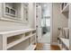 Hallway with console table, large mirror and access to secondary rooms in the home at 8890 S Quatar Ct, Aurora, CO 80016