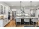 Gourmet kitchen boasts white cabinetry, a large island with seating, and stainless steel appliances at 8890 S Quatar Ct, Aurora, CO 80016