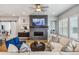 Inviting living room featuring a stone fireplace, wood floors, and stylish furnishings at 8890 S Quatar Ct, Aurora, CO 80016