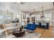 Open-concept living room and kitchen with stylish furniture, hardwood floors, and modern appliances at 8890 S Quatar Ct, Aurora, CO 80016