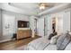 Spacious main bedroom featuring a tray ceiling, window shutters, hardwood flooring and ample closet space at 8890 S Quatar Ct, Aurora, CO 80016