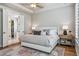 Main bedroom with a luxurious king bed, tray ceiling, and an en-suite bathroom and walk-in closet at 8890 S Quatar Ct, Aurora, CO 80016