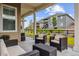 Inviting covered patio with comfortable seating, overlooking a landscaped yard and neighboring houses at 8890 S Quatar Ct, Aurora, CO 80016